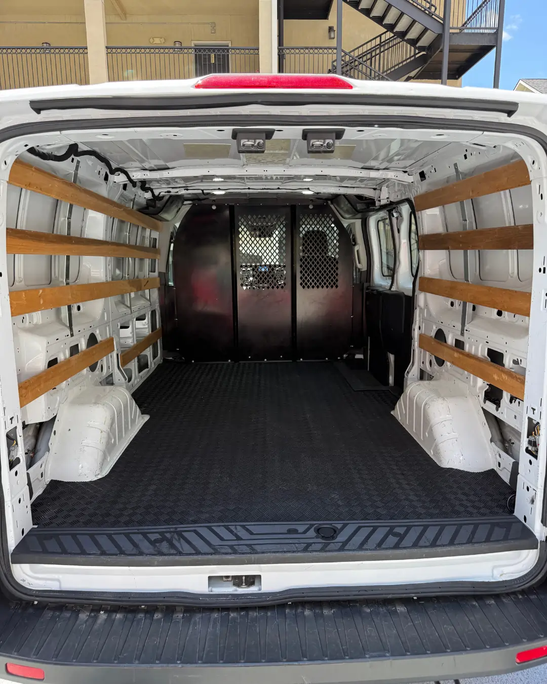 Cargo van load-in layout diagram showing mattress, bins, boxes and cooler positions